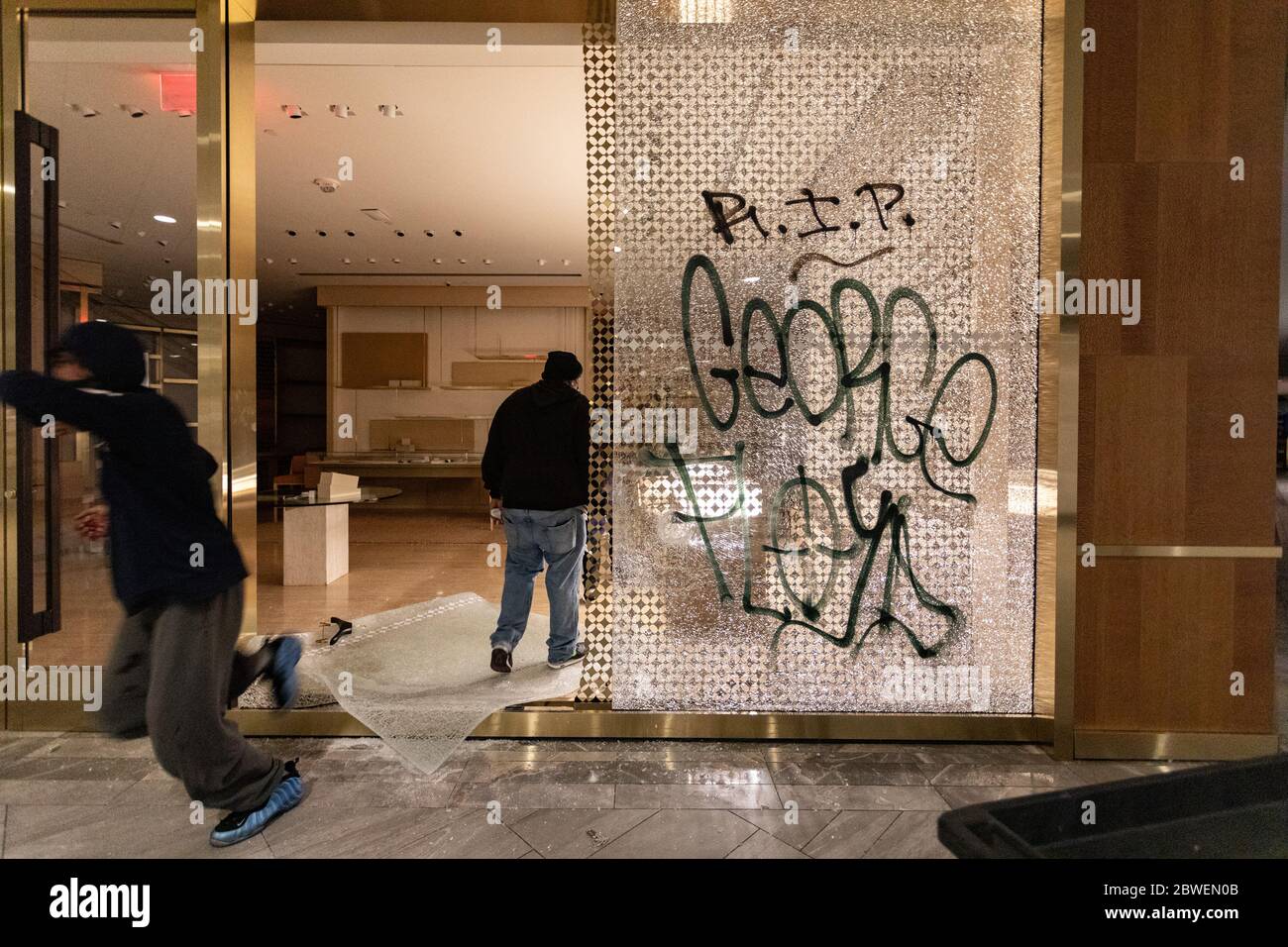 May 31, 2020, Boston, Massachusetts, USA: A looter inside Louis Vuitton  inside Copley Place in Boston. Many stores in downtown Boston were looted  following a rally against the death of George in