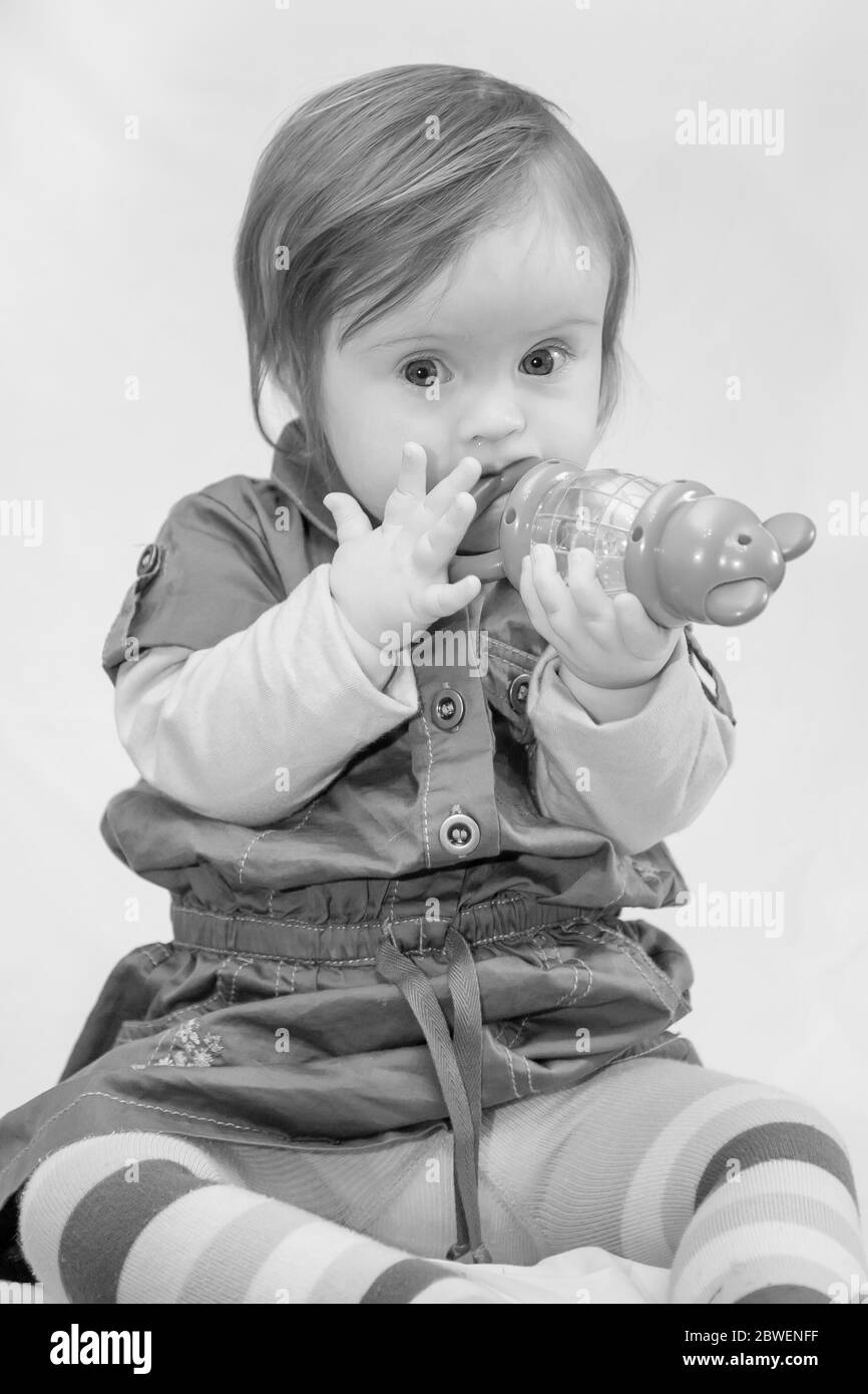 Young 2 year old child with Downs Syndrome happerly playing