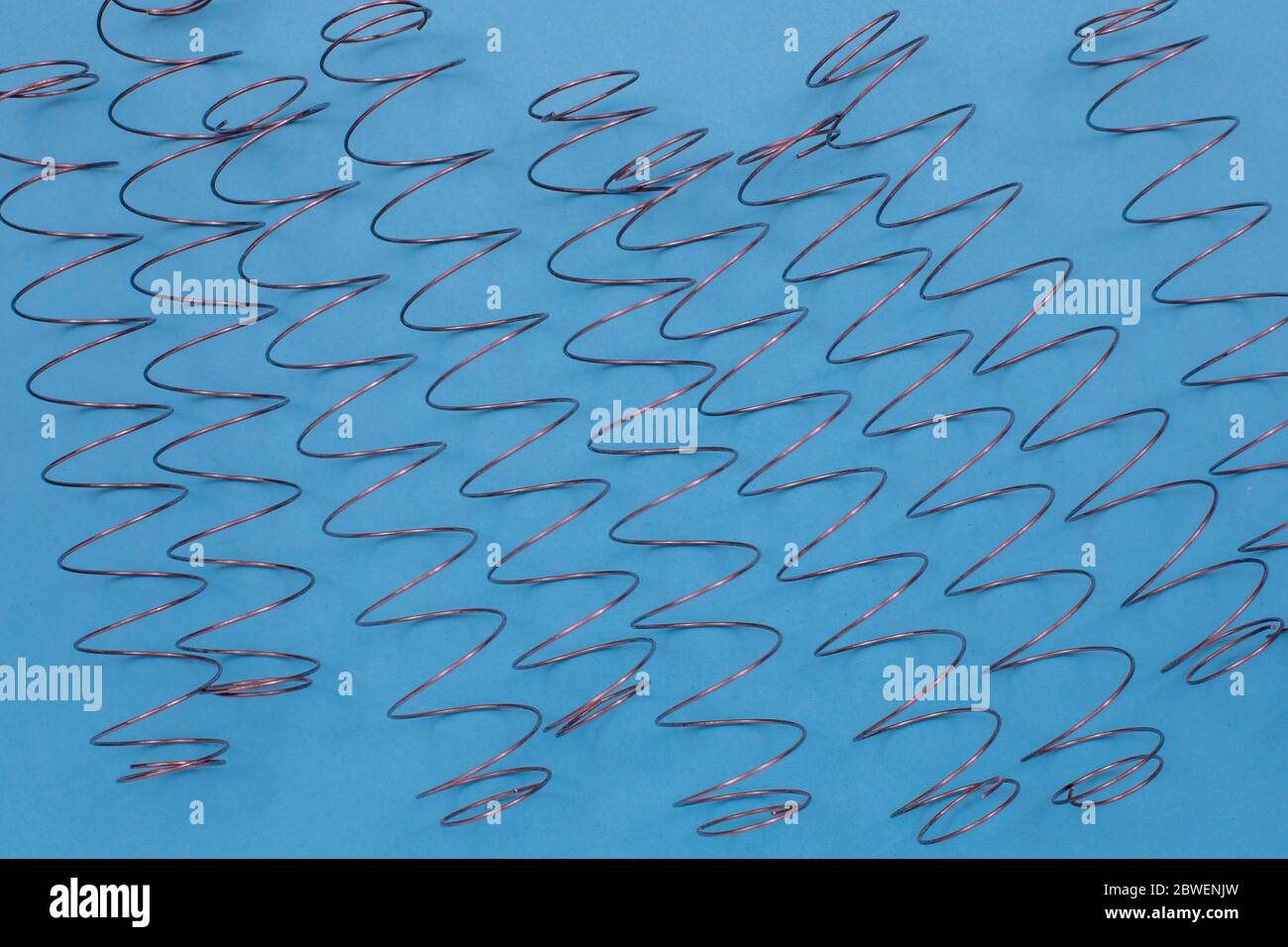 Independent mattress springs on the table. Top view with copy space, flat lay. Stock Photo