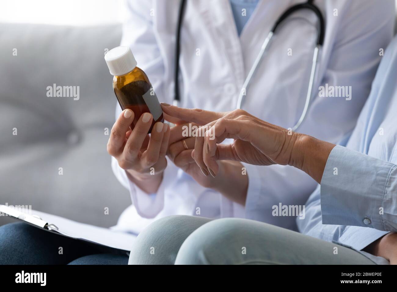 Closeup view nurse holding pills explain to elderly patient dosage Stock Photo