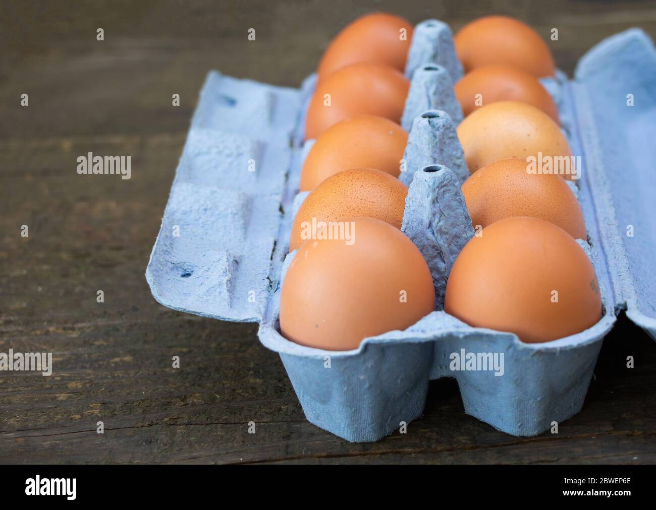 A box of chicken eggs on wooden background Stock Photo