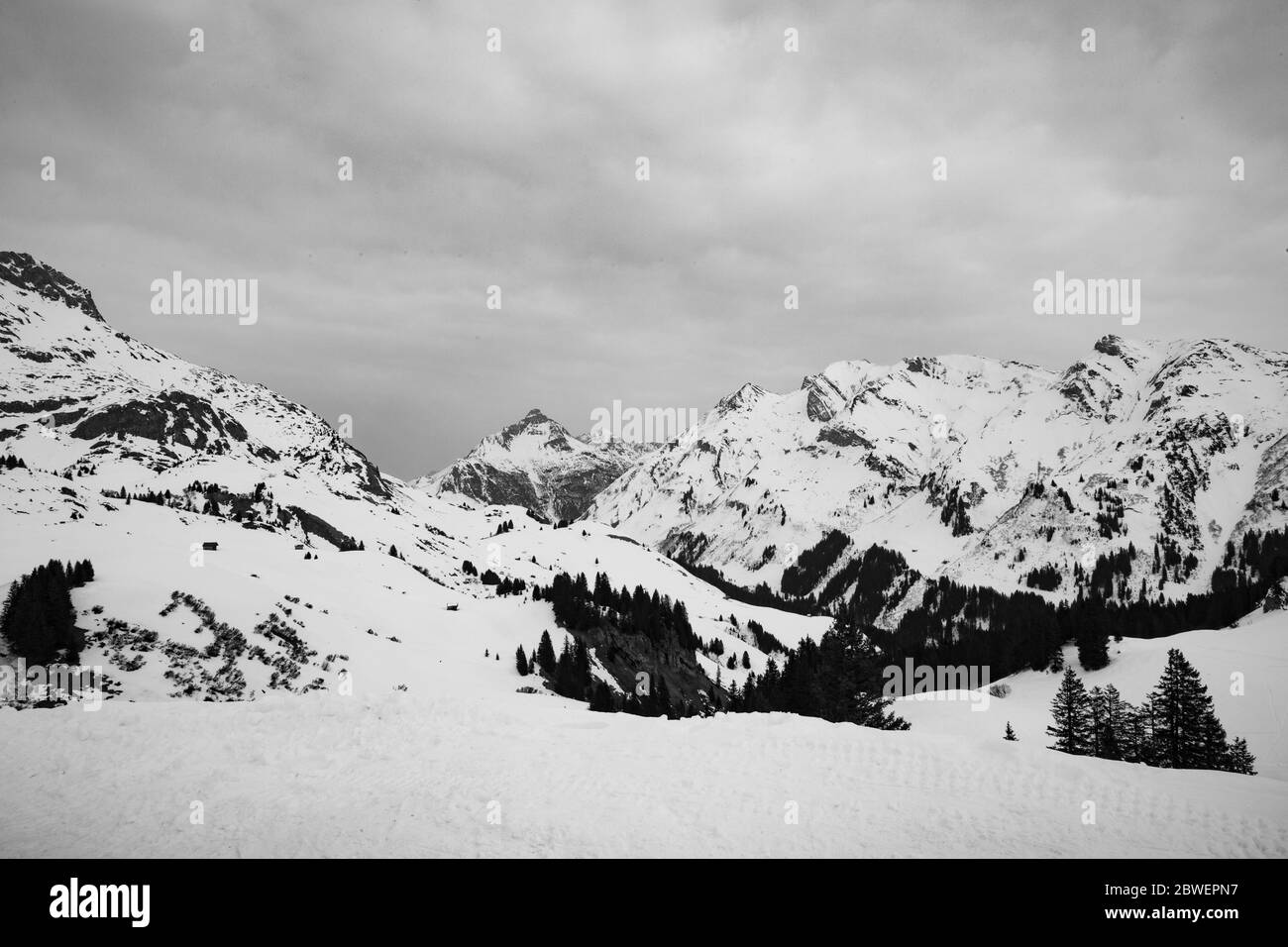 black and white photo of a spectacular mountain range  with dramatic clouds in the Arlberg region, Tirol, Austria Stock Photo