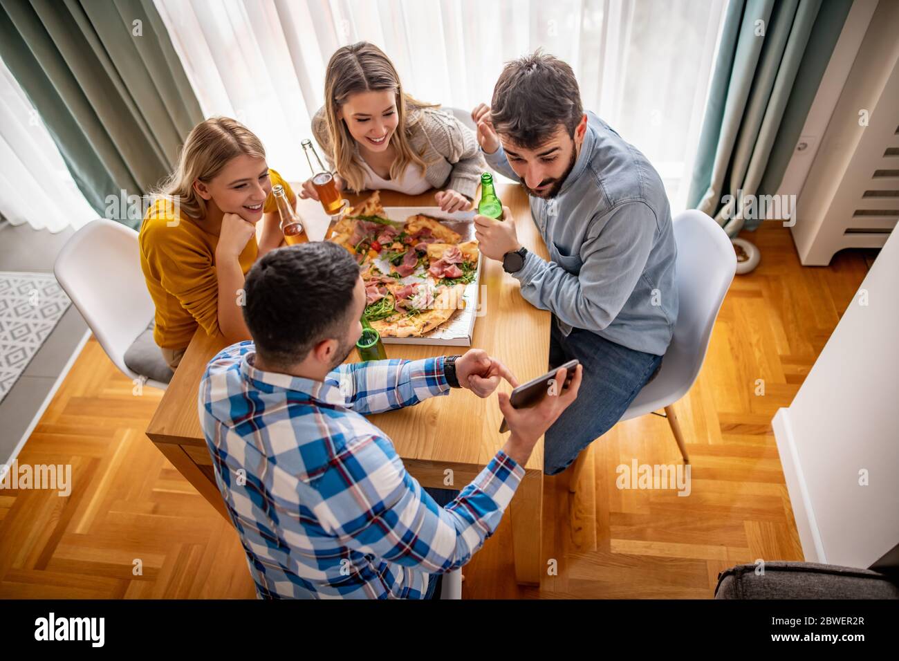 Group Of Friends Eating Pizza Together At Home Stock Photo, Picture and  Royalty Free Image. Image 56950664.