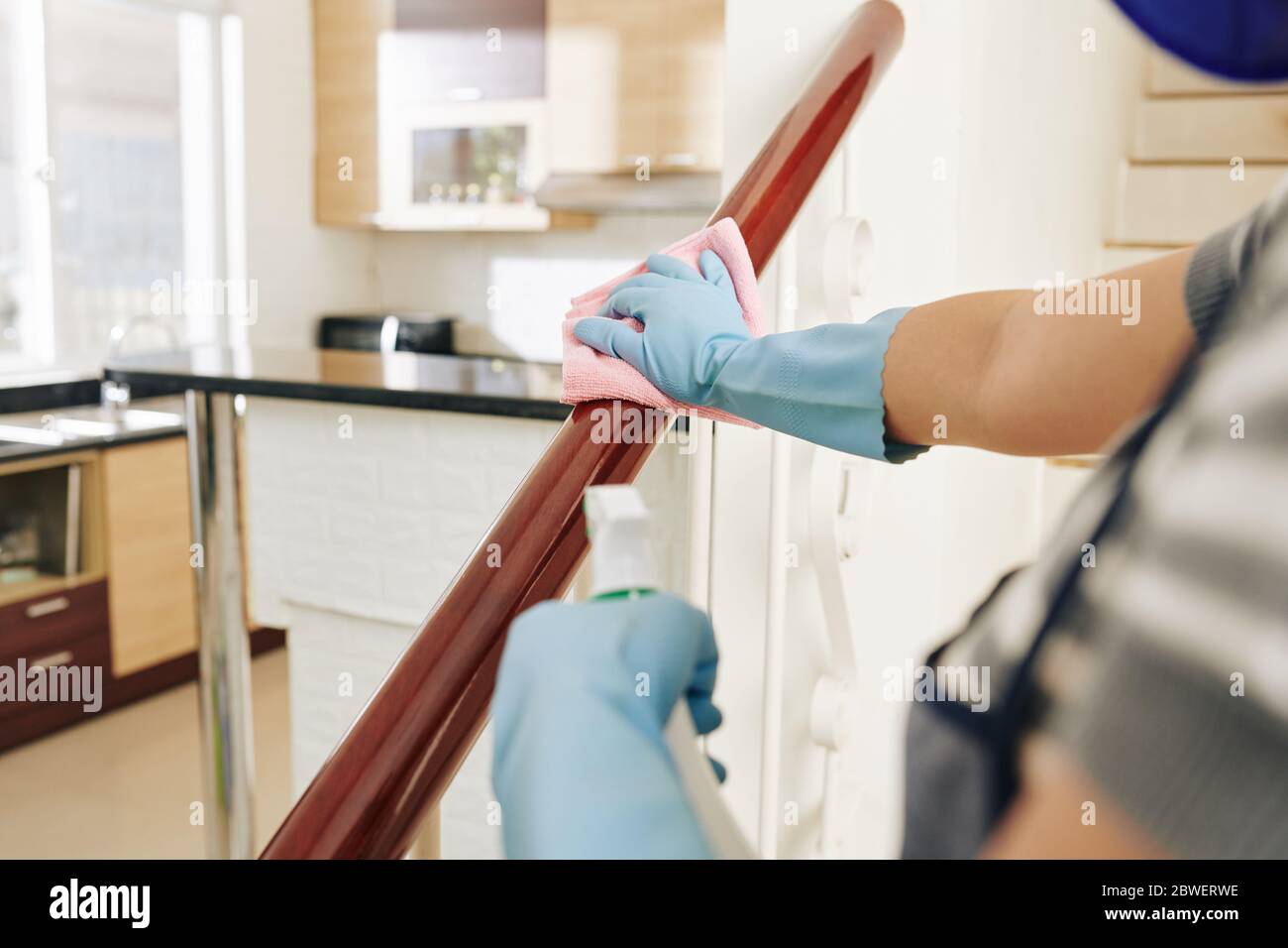 Wipe For Railing Housewife wiping staircase railing with disinfecting spray Stock Photo ...