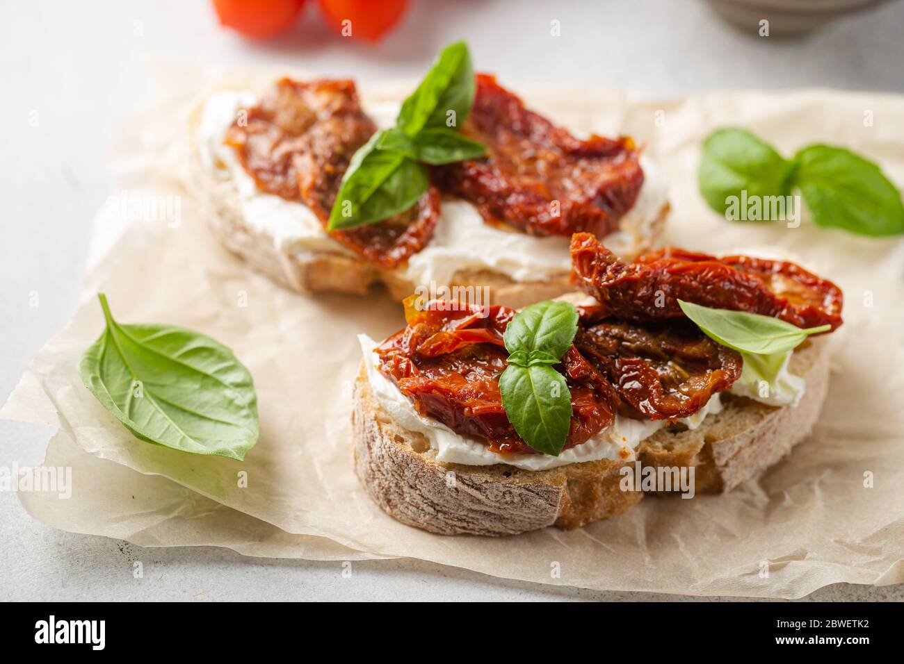 Bruschetta with sundried tomatoes, cottage cheese and fresh basil. Tasty savory Italian