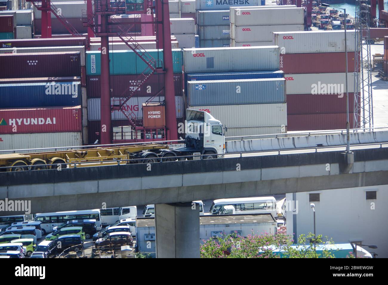 Hong Kong, China - Nov 28, 2016: Empty trailer truck on elevated road with container yard in hongkong port as background Stock Photo