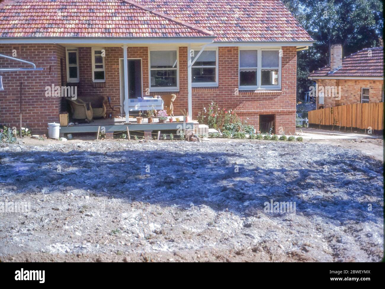 Sydney Australia 1959: Frost on a yet to be turfed back yard in front of a newly completed red brick home in Turramurra on Sydney's north shore in Australia. Grace Bros (department store) Home Plans Service, established in association with the Sunday Telegraph Newspaper, Sydney, was launched in April 1954 and this home is based on one of those plans. See also Alamy Image ID 2HYHTMN for the uncompleted home Stock Photo