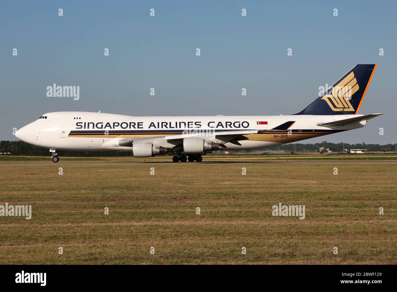 Singapore Airlines Cargo Boeing 747-400F with registration 9V-SFD rolling on taxiway V of Amsterdam Airport Schiphol. Stock Photo