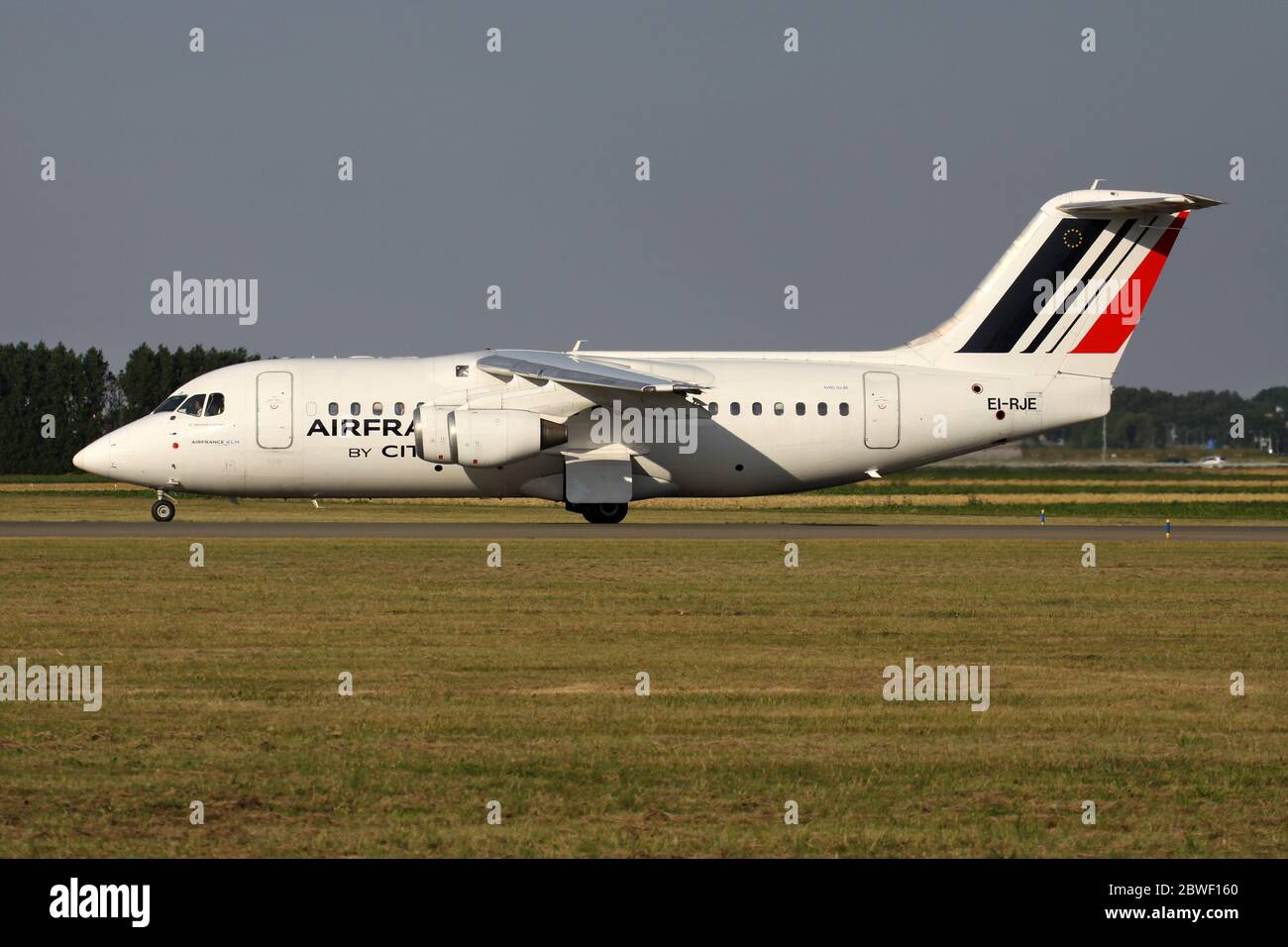 Irish CityJet Avro RJ85 in Air France livery with registration EI-RJE rolling on taxiway V of Amsterdam Airport Schiphol. Stock Photo