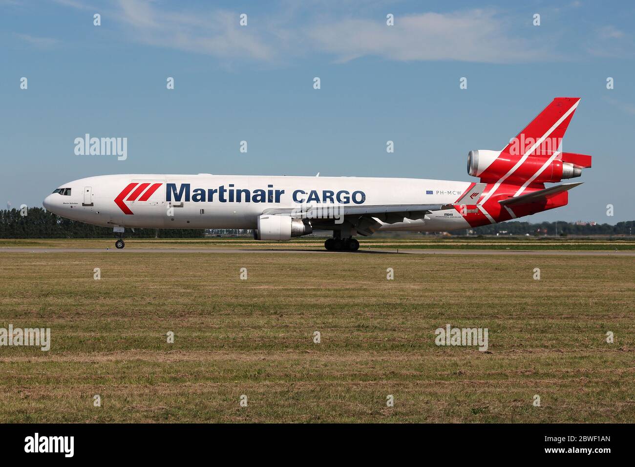 Dutch Martinair Cargo McDonnell Douglas MD-11 with registration PH-MCW rolling on taxiway V of Amsterdam Airport Schiphol. Stock Photo