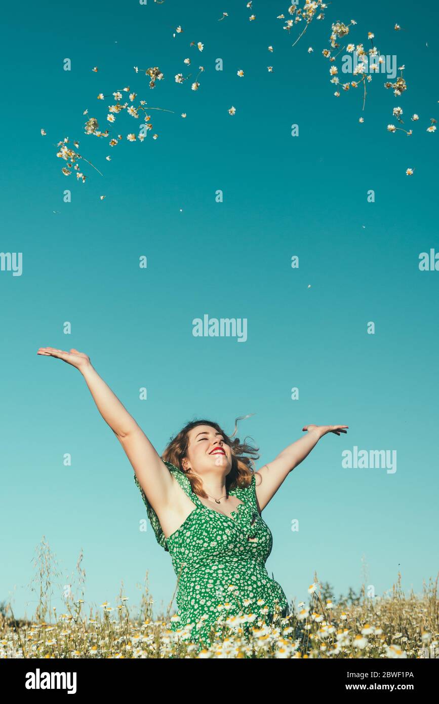 Smiling beautiful woman throwing flowers Stock Photo Alamy
