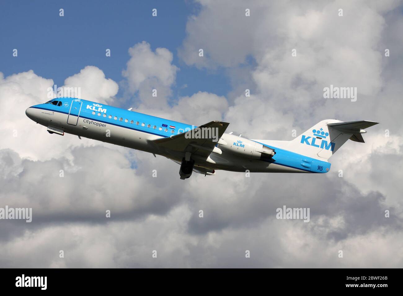 Dutch KLM Cityhopper Fokker 70 with registration PH-WXD just airborne at Amsterdam Airport Schiphol. Stock Photo