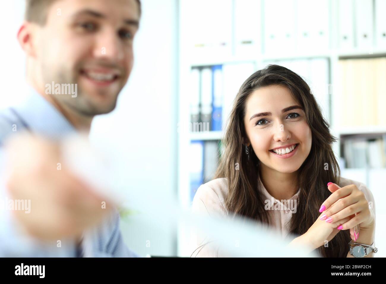 Joyful young colleagues working together at their project Stock Photo