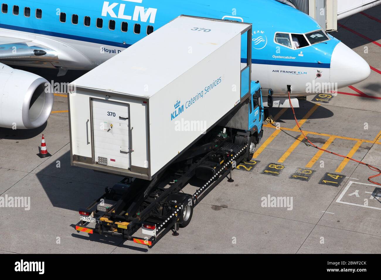 KLM Catering Services truck serving KLM Boeing 737 at Amsterdam Airport Schiphol. Stock Photo