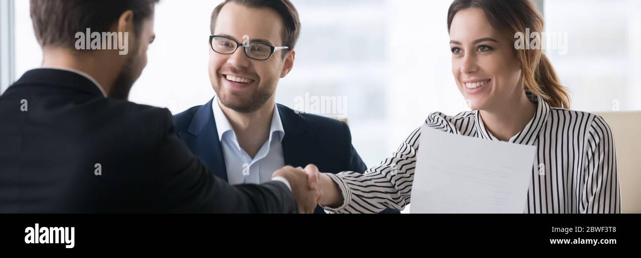 Bank workers and client make deal shake hands horizontal image Stock Photo
