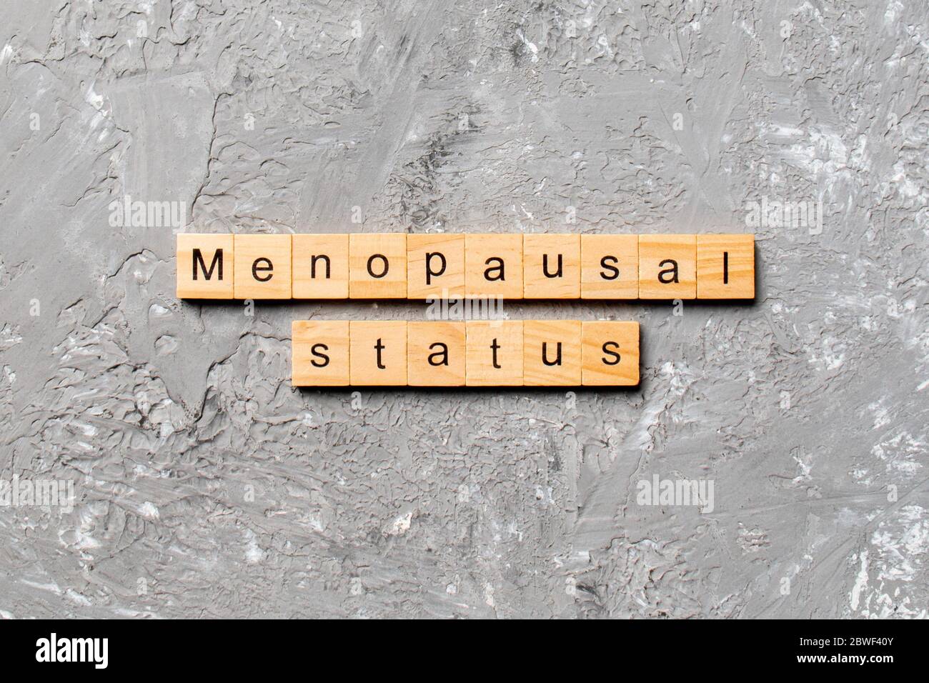 menopausal status word written on wood block. menopause status text on cement table for your desing, concept. Stock Photo