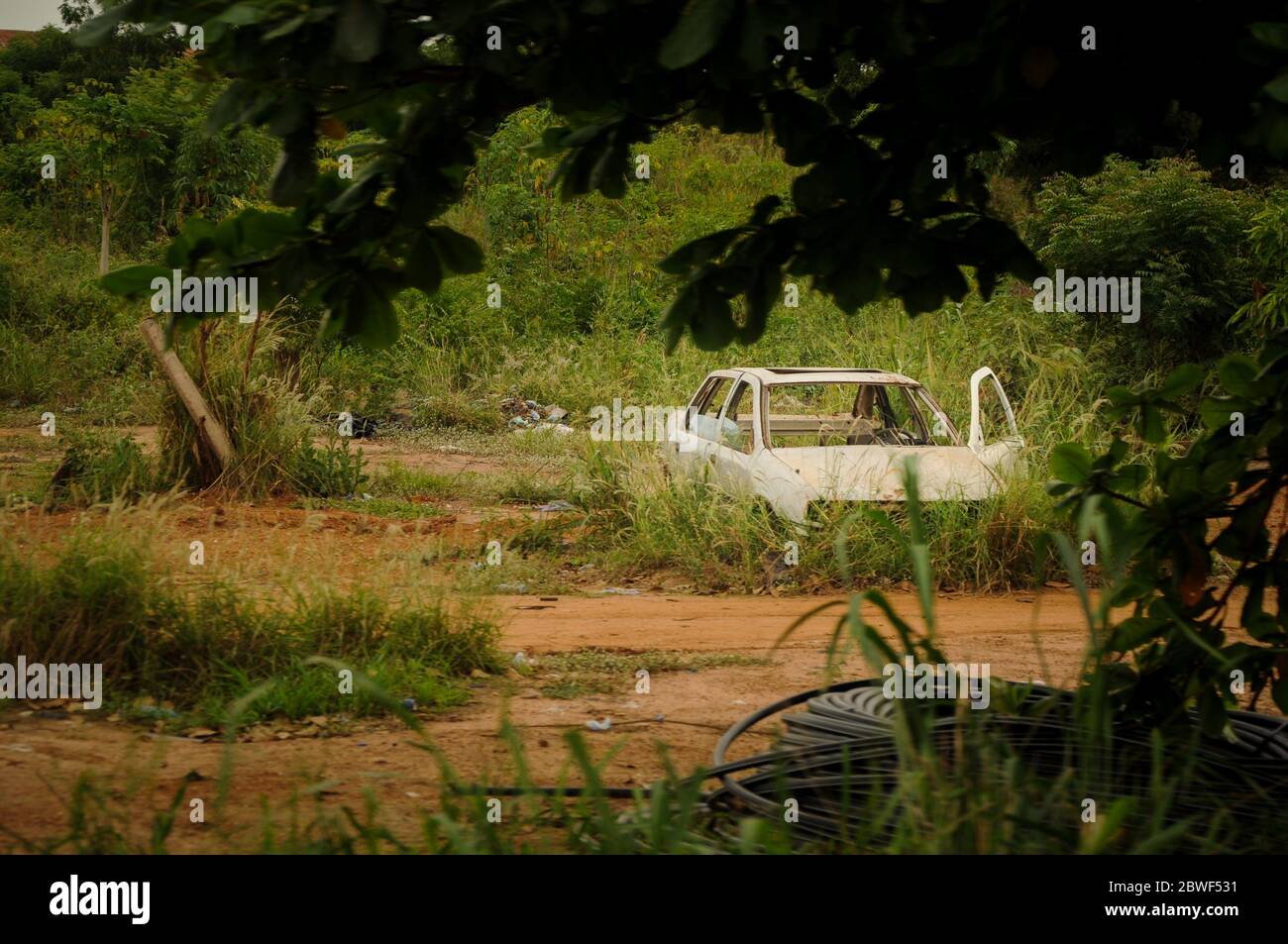 Car wreck in the middle of the African rainforest - near Accra, Ghana, Africa Stock Photo