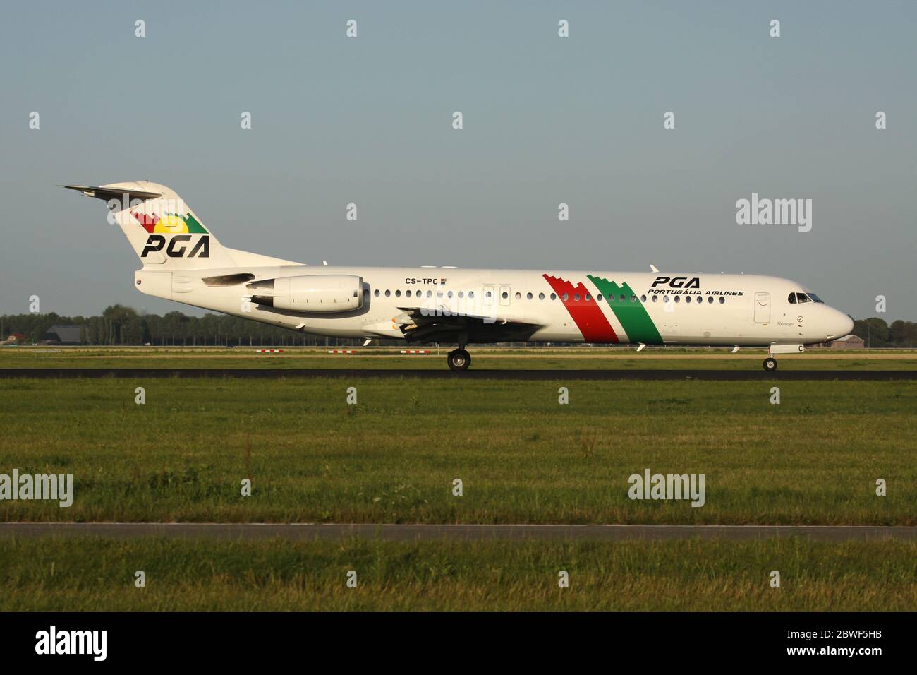 PGA Portugalia Airlines Fokker 100 with registration CS-TPC just landed on runway 18R (Polderbaan) of Amsterdam Airport Schiphol. Stock Photo