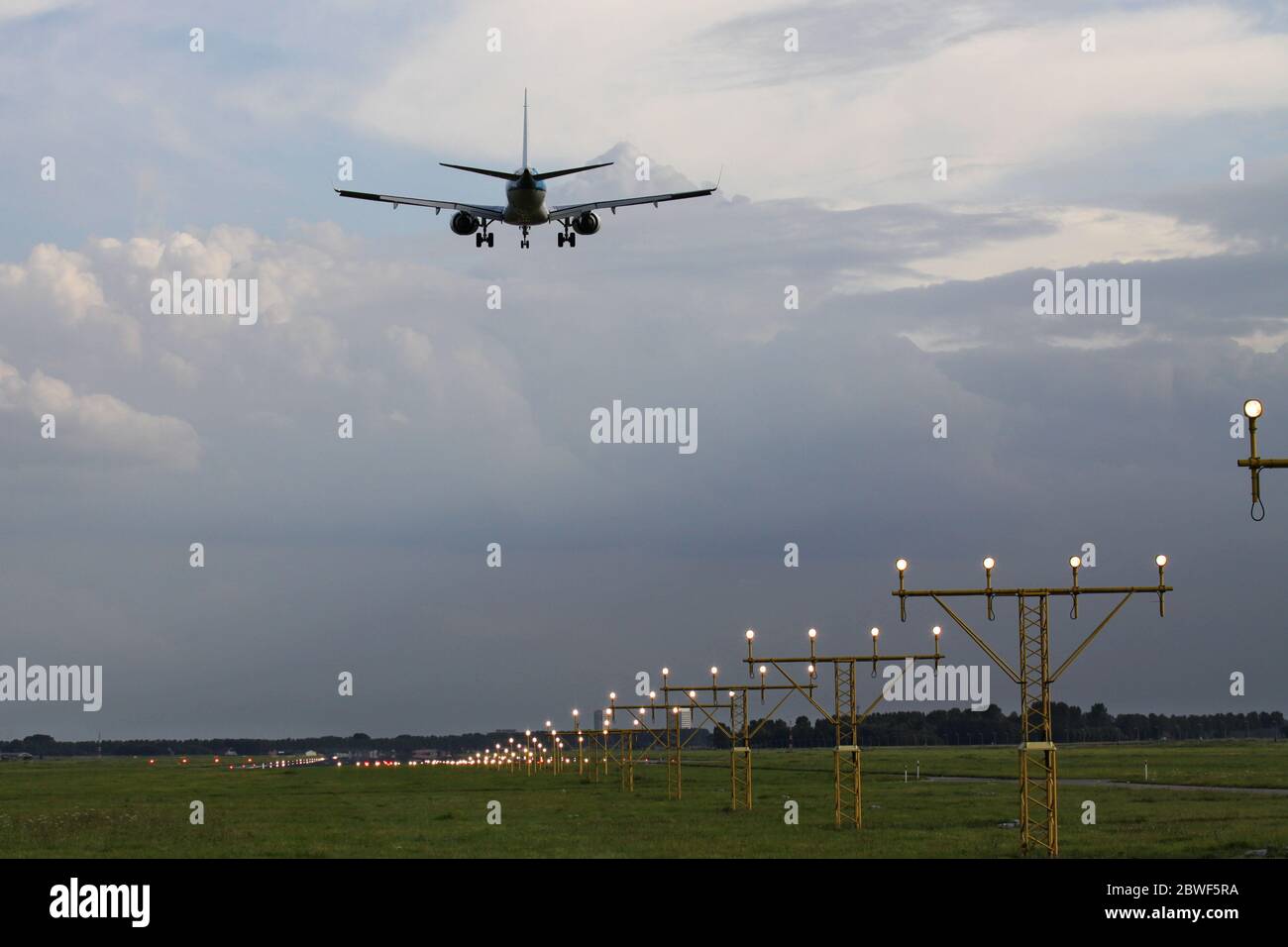 aircraft on shot final following landing strip lights Stock Photo