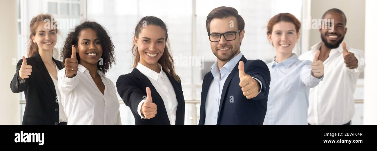 Group of multiethnic employees showing thumbs up gesture horizontal photo Stock Photo