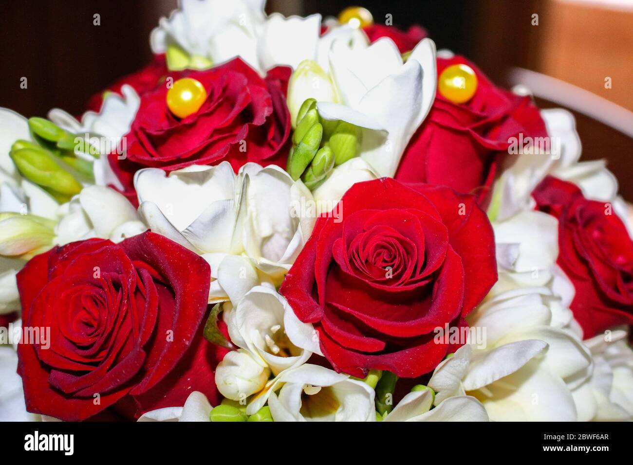 Bouchet of the bride, made of red roses and white flowers. 50 years of marriage. Stock Photo