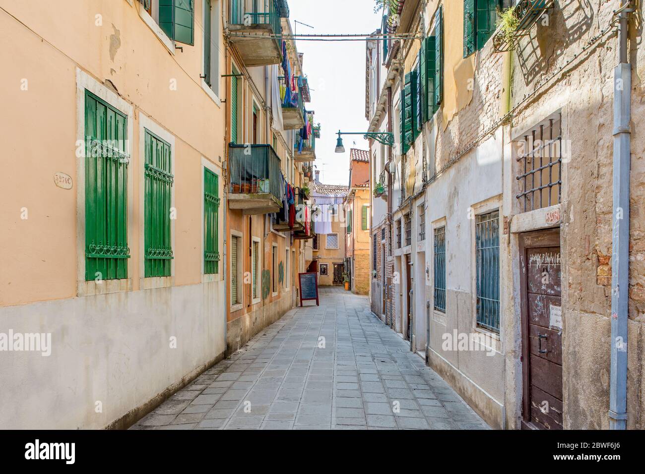 An alley between apartment buildings in the city of venice Stock Photo