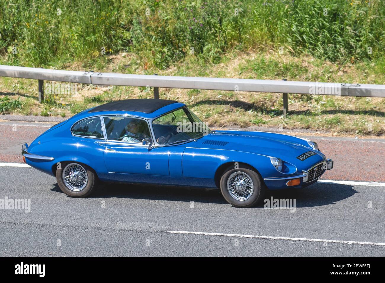 1972 70s seventies Blue Jaguar 2+2 E Type; Vehicular traffic moving vehicles, cars driving vehicle on UK roads, motors, motoring on the M6 motorway highway Stock Photo