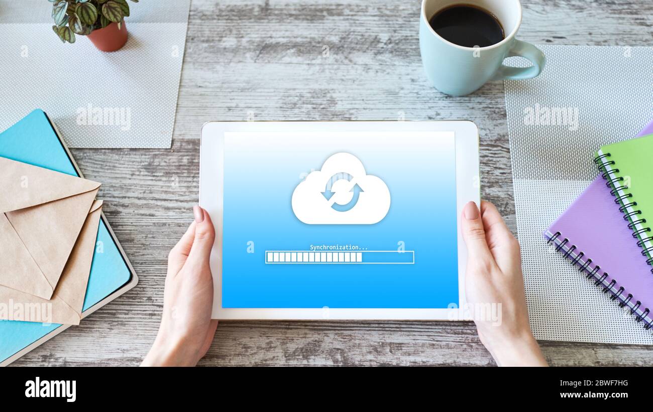 Cloud synchronization progress bar on tablet screen. Data storage and protection. Technology and internet concept Stock Photo