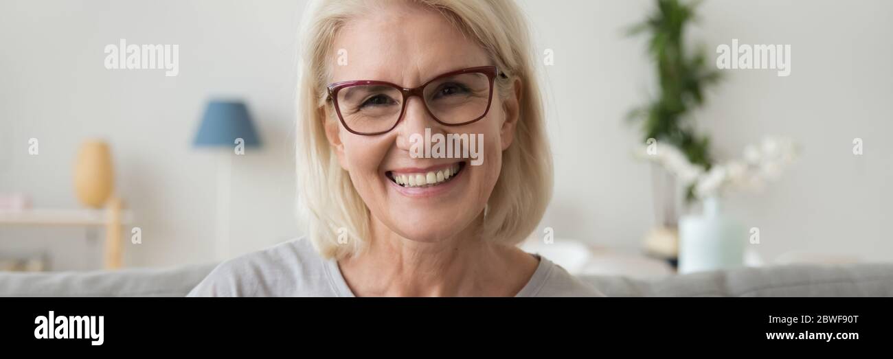 Mature woman in glasses smiling looking at camera horizontal photo Stock Photo