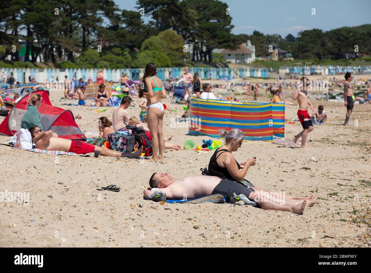 Crowds enjoy the hot weather at Avon beach, Mudeford as the coronavirus lockdown measures are relaxed to enable people to travel to the south coast. Stock Photo