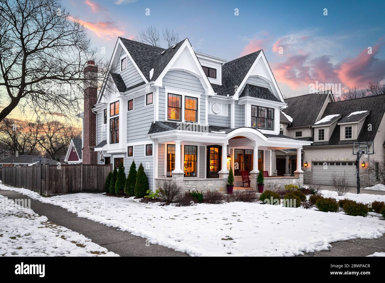 A large suburban house at sunset with beautiful, dramatic clouds and snow  on the ground Stock Photo - Alamy, image size:1300x956