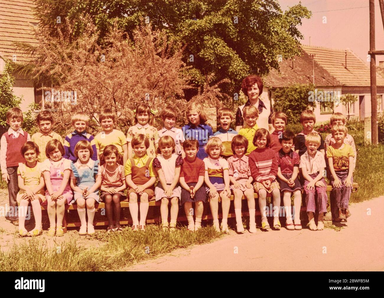THE CZECHOSLOVAK SOCIALIST REPUBLIC - CIRCA 1980s: Retro photo shows pupils (schoolmates) and their female teacher. Color photo. Stock Photo