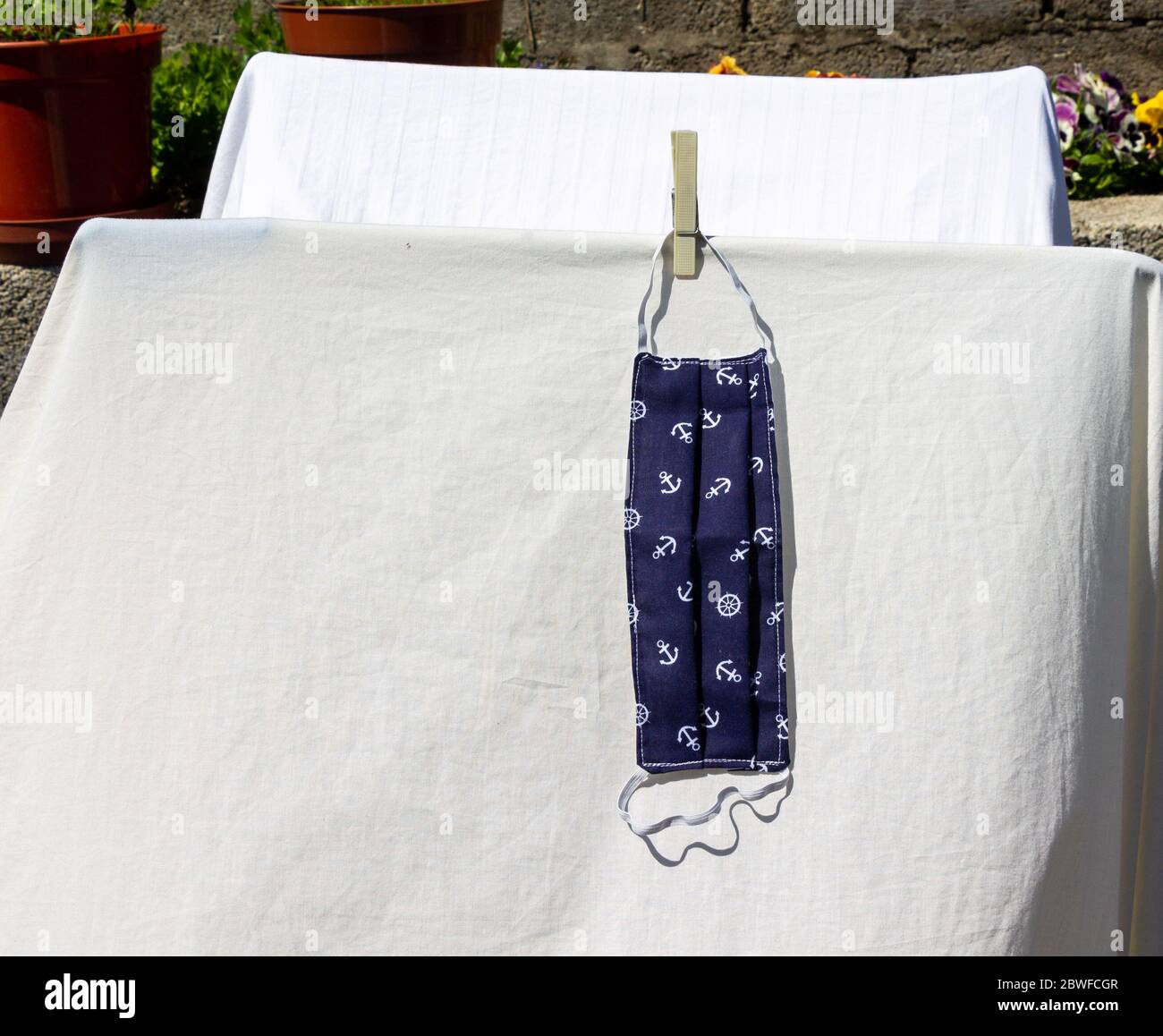 Coronavirus Face Mask washed and drying on a washing line Stock Photo