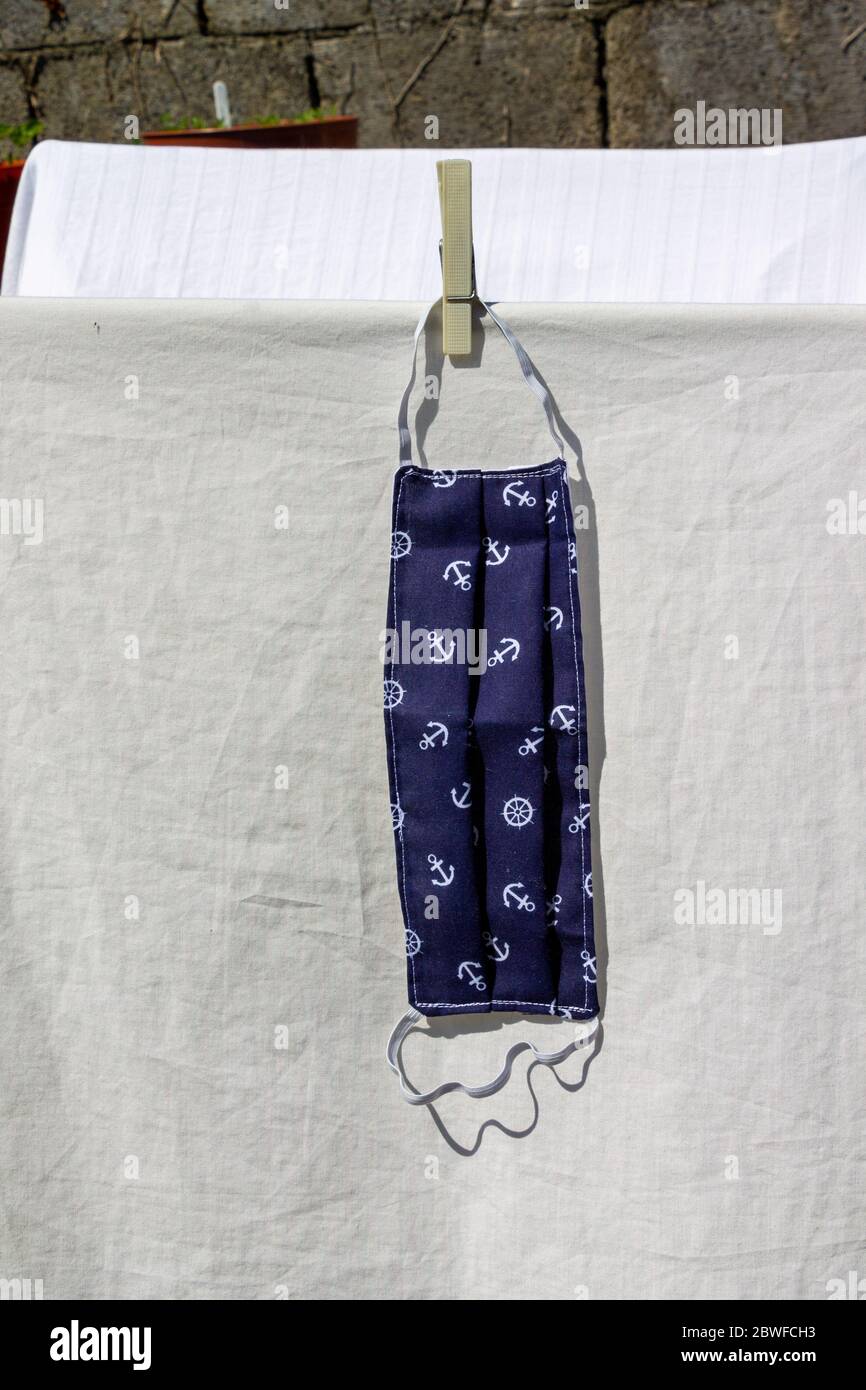 Coronavirus Face Mask washed and drying on a washing line Stock Photo