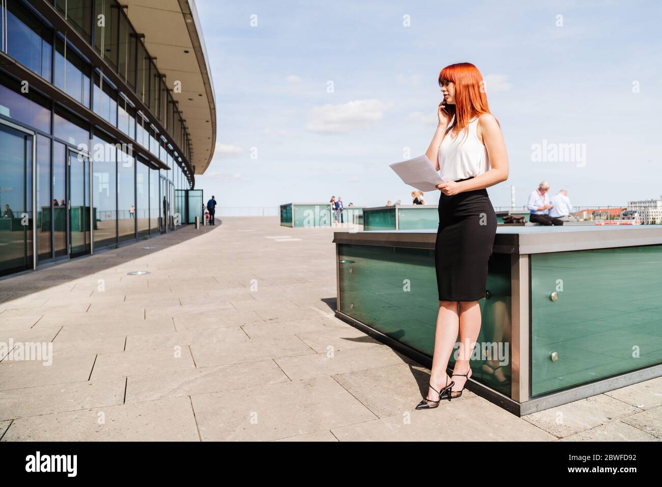 Young redhead business woman in formal outside Stock Photo - Alamy