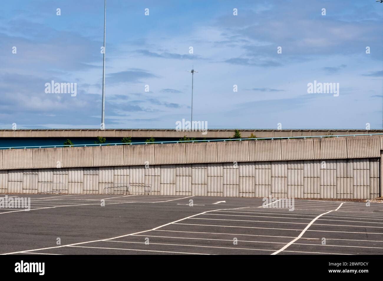 An empty car park with a motorway in the background in Glasgow, Scotland Stock Photo