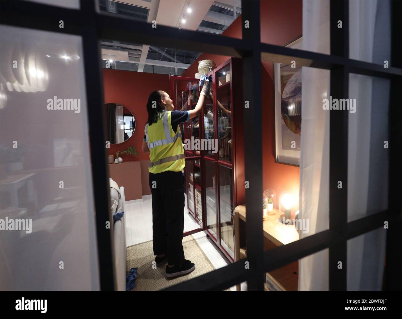 Ikea staff cleaning a display inside the IKEA Tottenham store in Edmonton, north London, as it