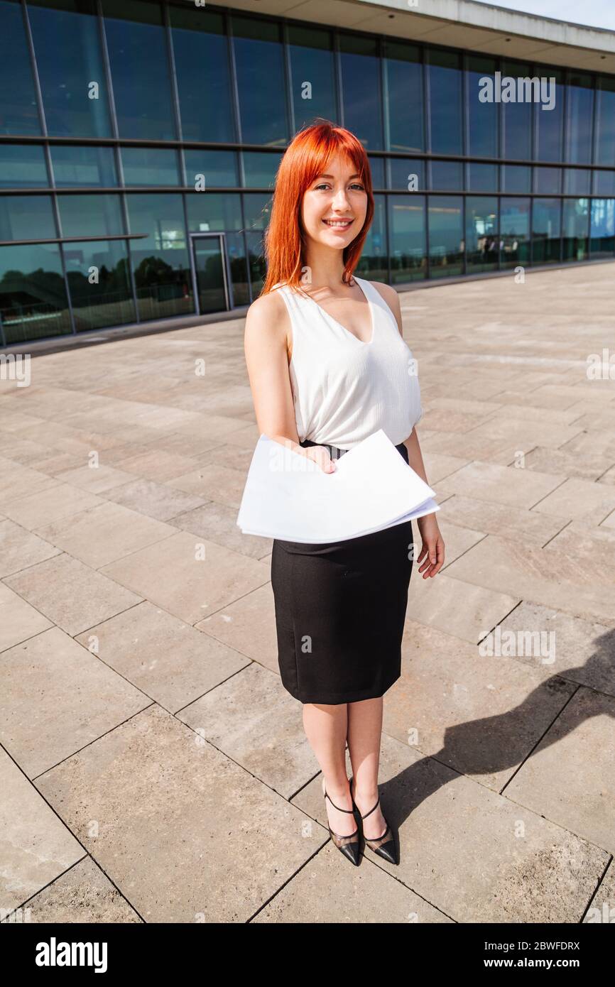 Young redhead business woman in formal outside Stock Photo - Alamy