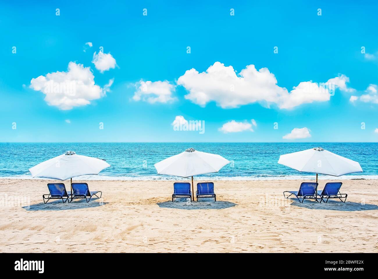 Chairs and umbrellas on a tropical beach Stock Photo