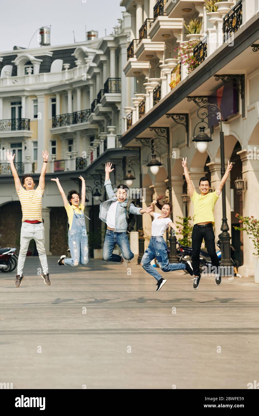 Excited young Asian people jumping, shouting and raising hands Stock ...