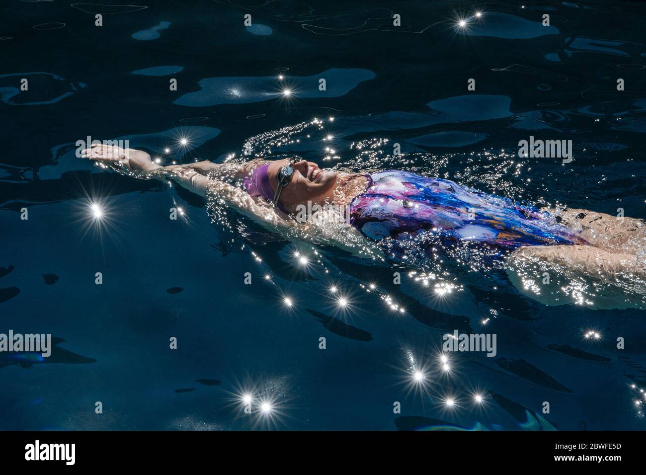 Woman in one piece swimsuit swimming in pool Stock Photo - Alamy