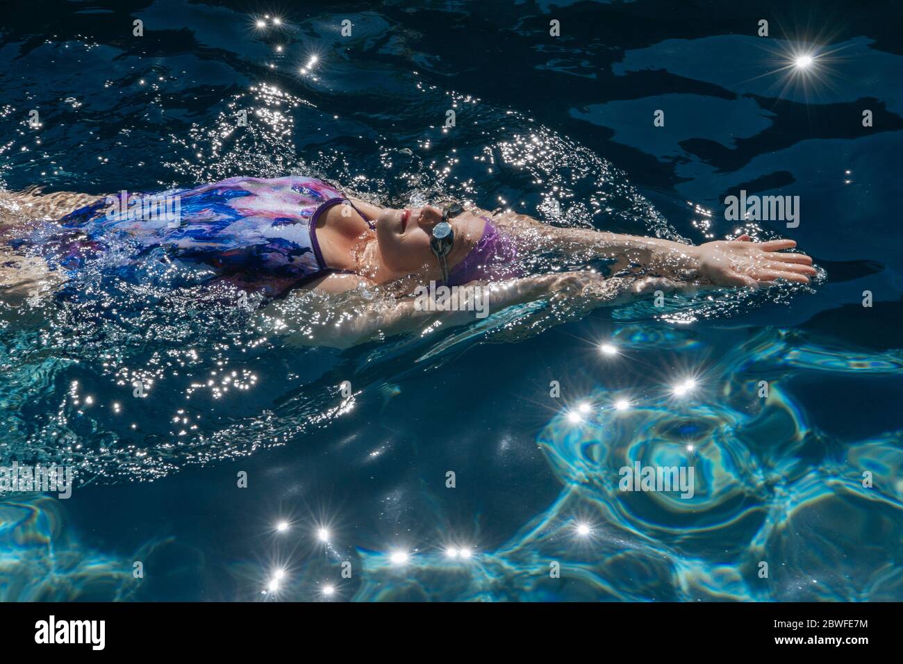 Woman in one piece swimsuit swimming in pool Stock Photo - Alamy