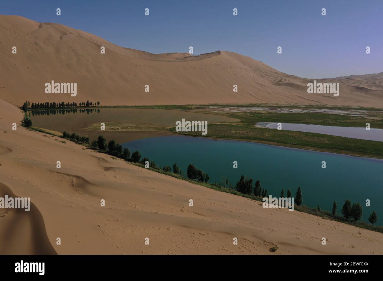 Araxan Right Banner. 30th May, 2020. Aerial photo taken on May 30, 2020 shows a lake in Badain Jaran Desert, north China's Inner Mongolia Autonomous Region. There are many lakes in the Badain Jaran Desert, which constitute a beautiful picture with deserts and plants. Credit: Xu Qin/Xinhua/Alamy Live News Stock Photo