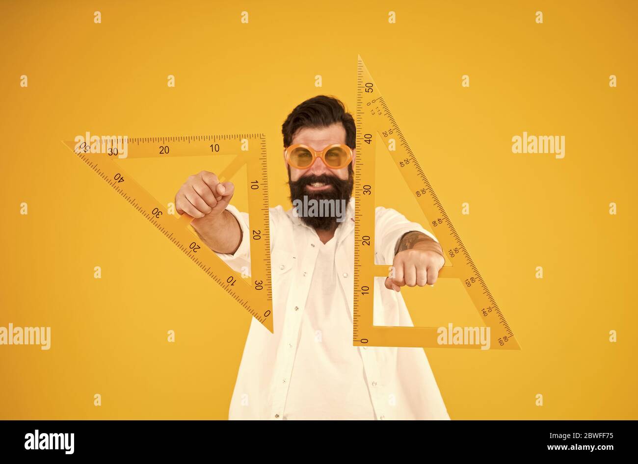 For drawing, draughting and design. Hipster holding drawing instruments on  yellow background. Architect and engineer using triangles for engineering  drawing. Geometry or technical drawing teacher Stock Photo - Alamy