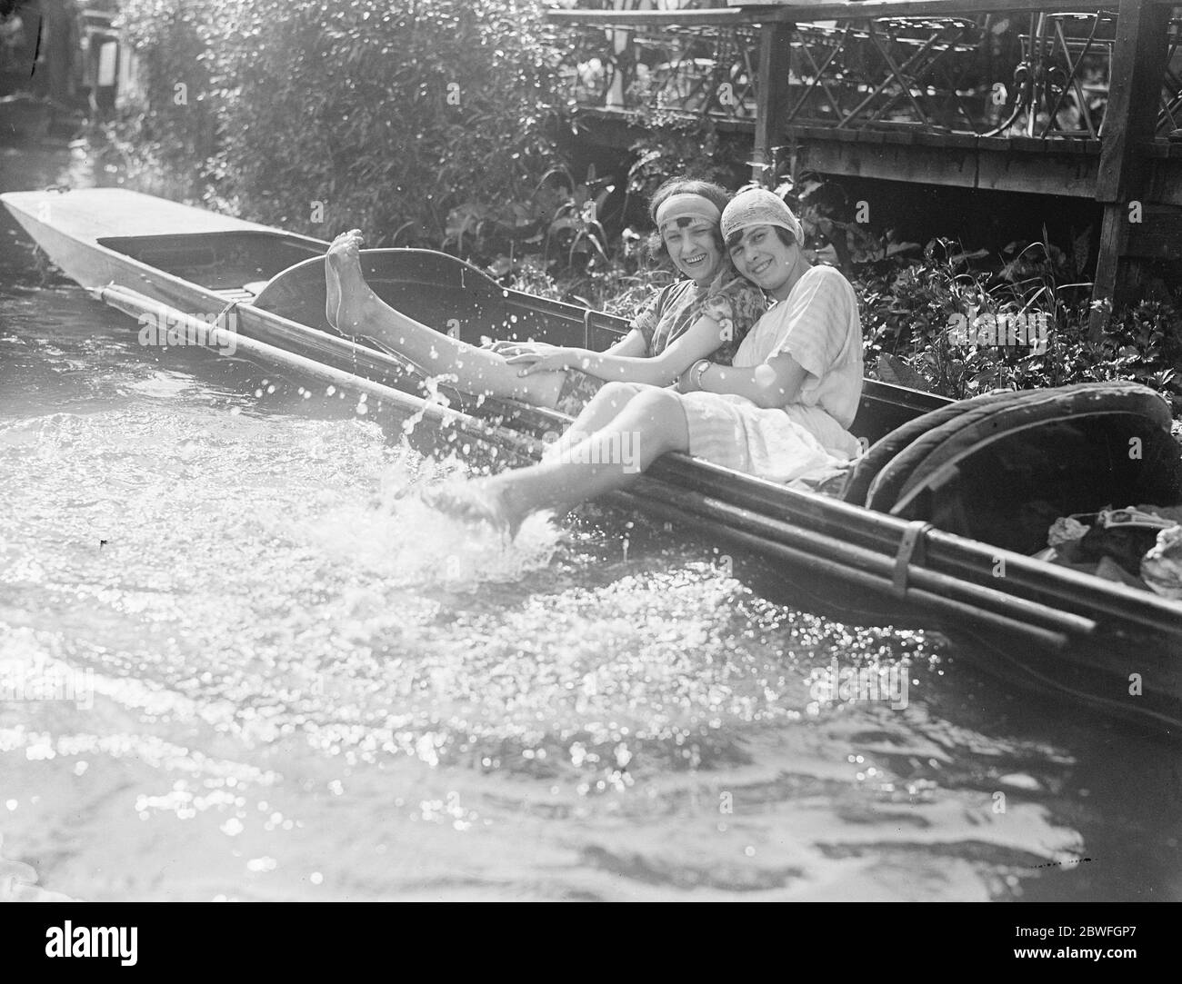 Foam Belles These happy river girls think that the smooth waters of the River Thames in Southern England look more refreshing with a head on them 27 May 1922 Stock Photo