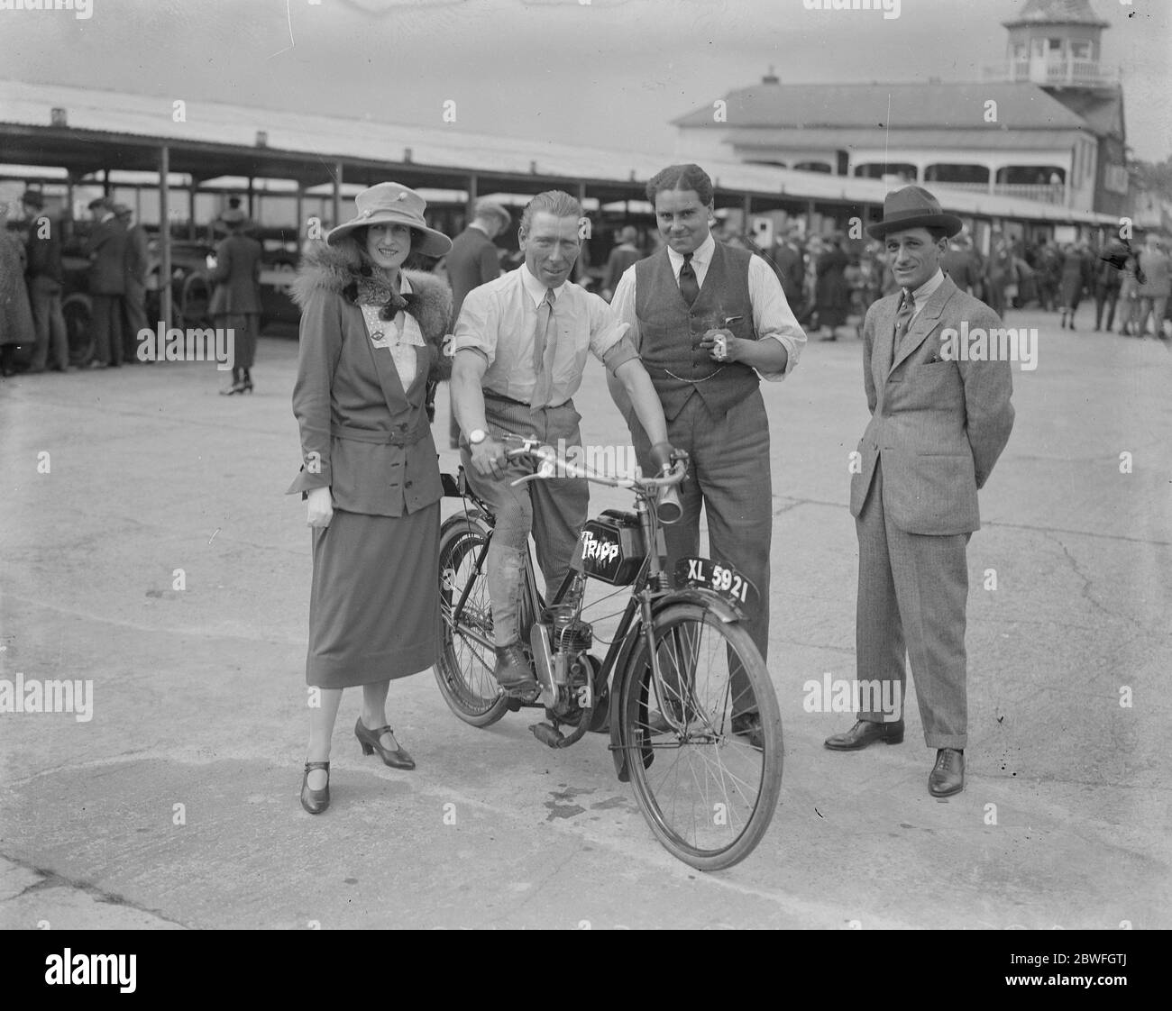 Motorcycling to all A new cycle which costs only £ 22 and does an average of 30 miles an hour George Duller the well known jockey with Mrs Duller , Bernard Carslake ( the jockey ) and Captain Woolf Barnarto with one of the new motor cycles 22 July 1922 Stock Photo