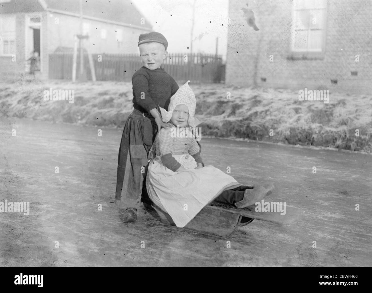 Holland Ice Bound Telegrams from Holland state a hard frost and fierce cold prevail and all canals frozen Two little Hollanders who have been making the most of the skating conditions of the frozen waterways 10 December 1921 Stock Photo