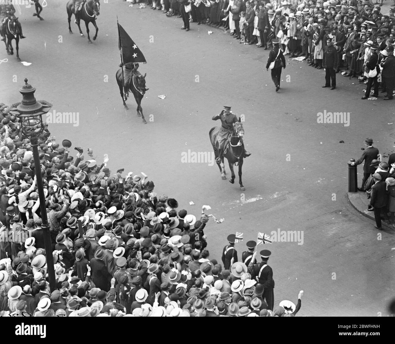 Todays great victory march . The crowd in Whitehall, London , cheering American General Pershing who is seen followed by his standard bearer . 19 July 1919 Stock Photo