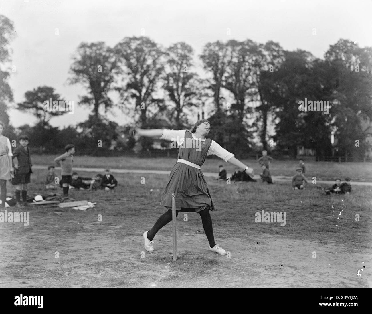 Brilliant girl bowler . An over - arm action study of Miss Ryle , the Captain of the Romford Girls Cricket Club , London . She recently took 7 wickets for 12 runs twice and 5 wickets for 10 runs in different games . 18 August 1922 Stock Photo