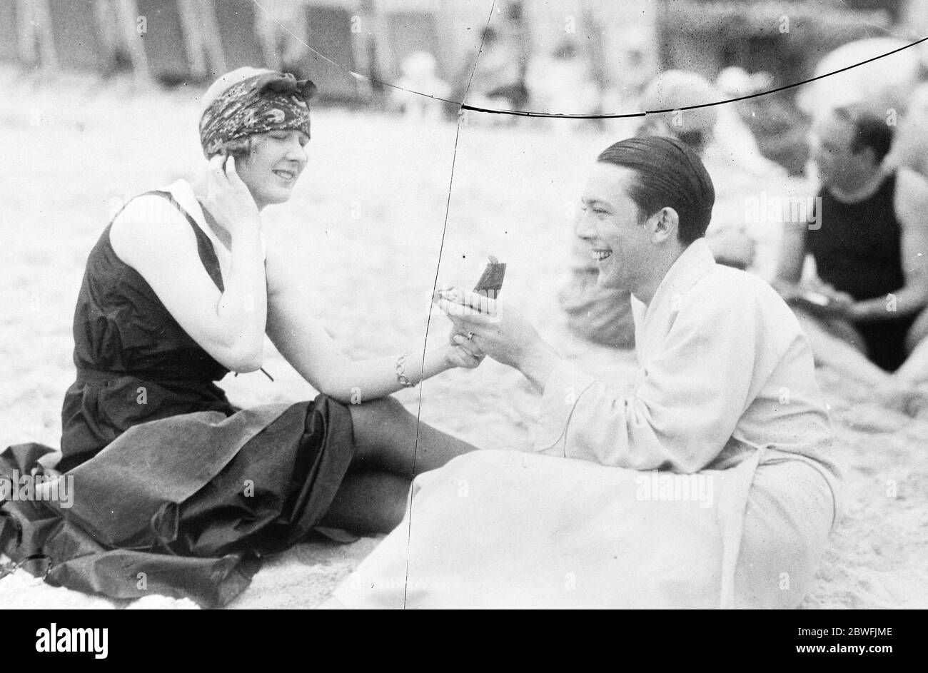 Vanity Fair Jack Pickford , the film star , holds his wife ' s vanity case up to her at Palm beach , Florida , where society is basking in the sunshine 23 Febrauary 1924 Stock Photo